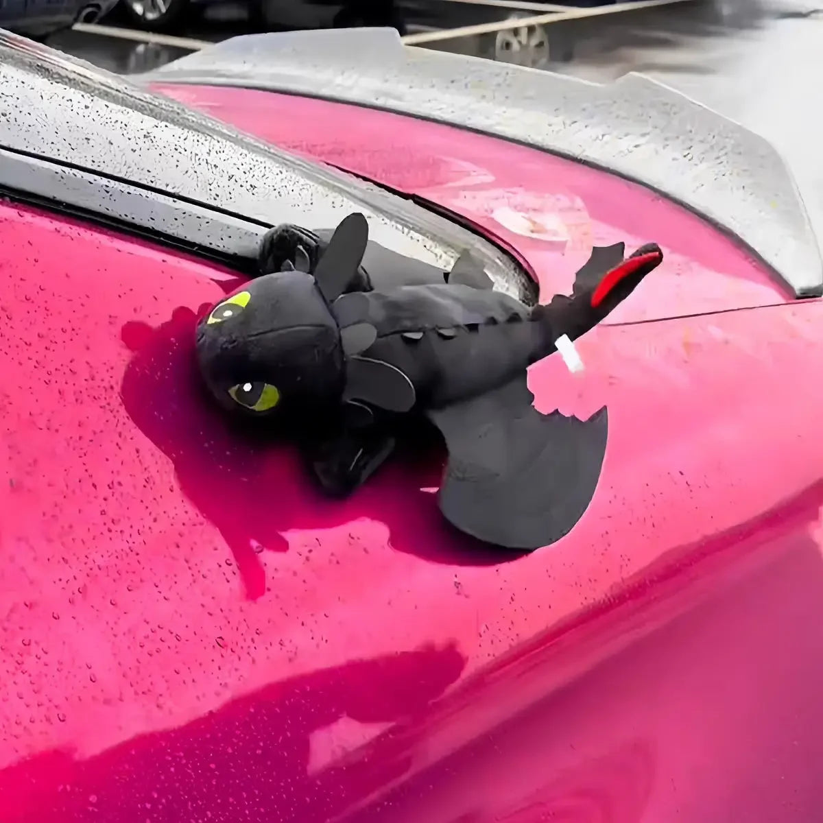 Cartoon plush dragon on the roof of a car